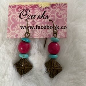 Earrings by Ozarks. Turquoise, dark, pink, and brass color beads.